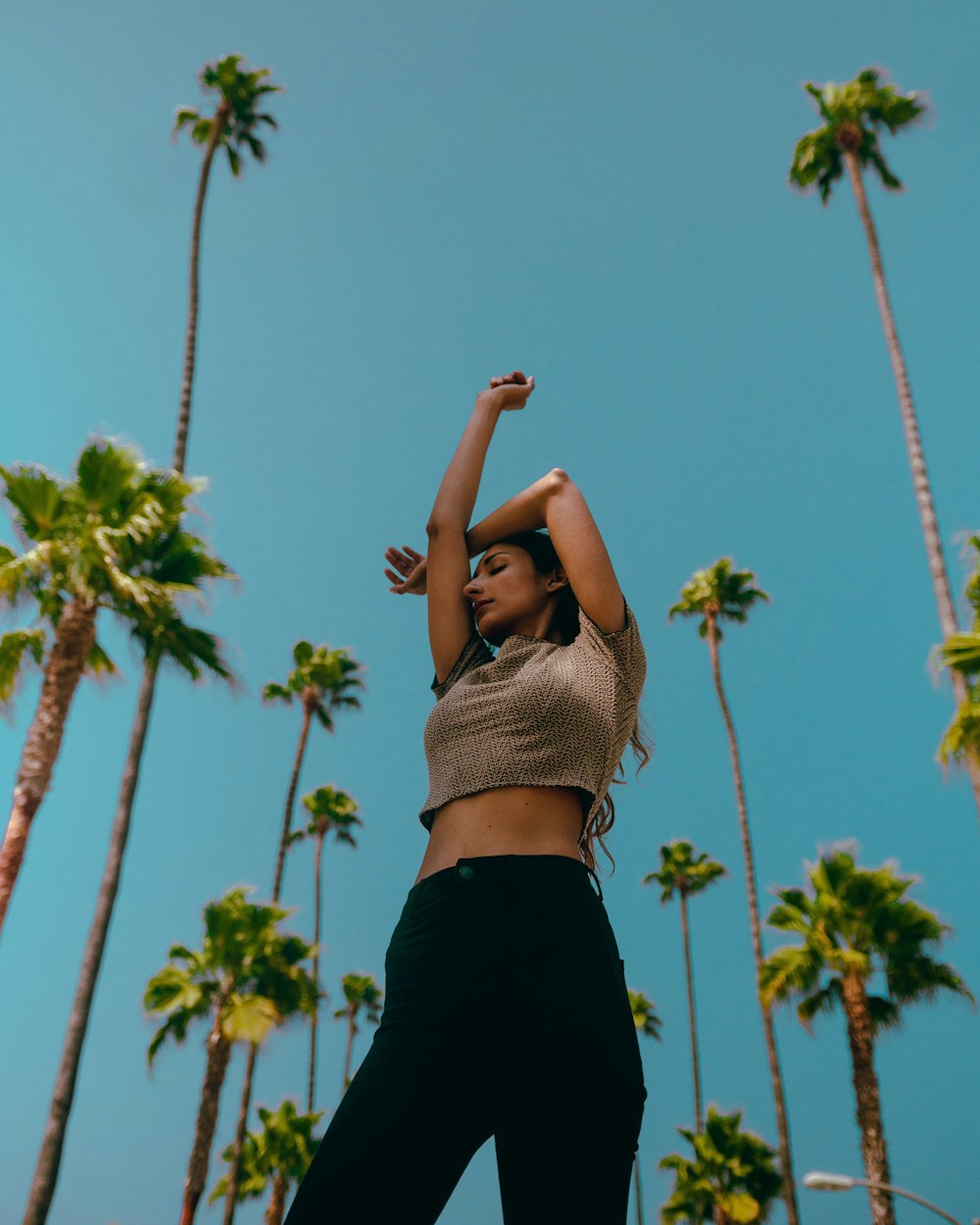 woman in black skirt raising her hands