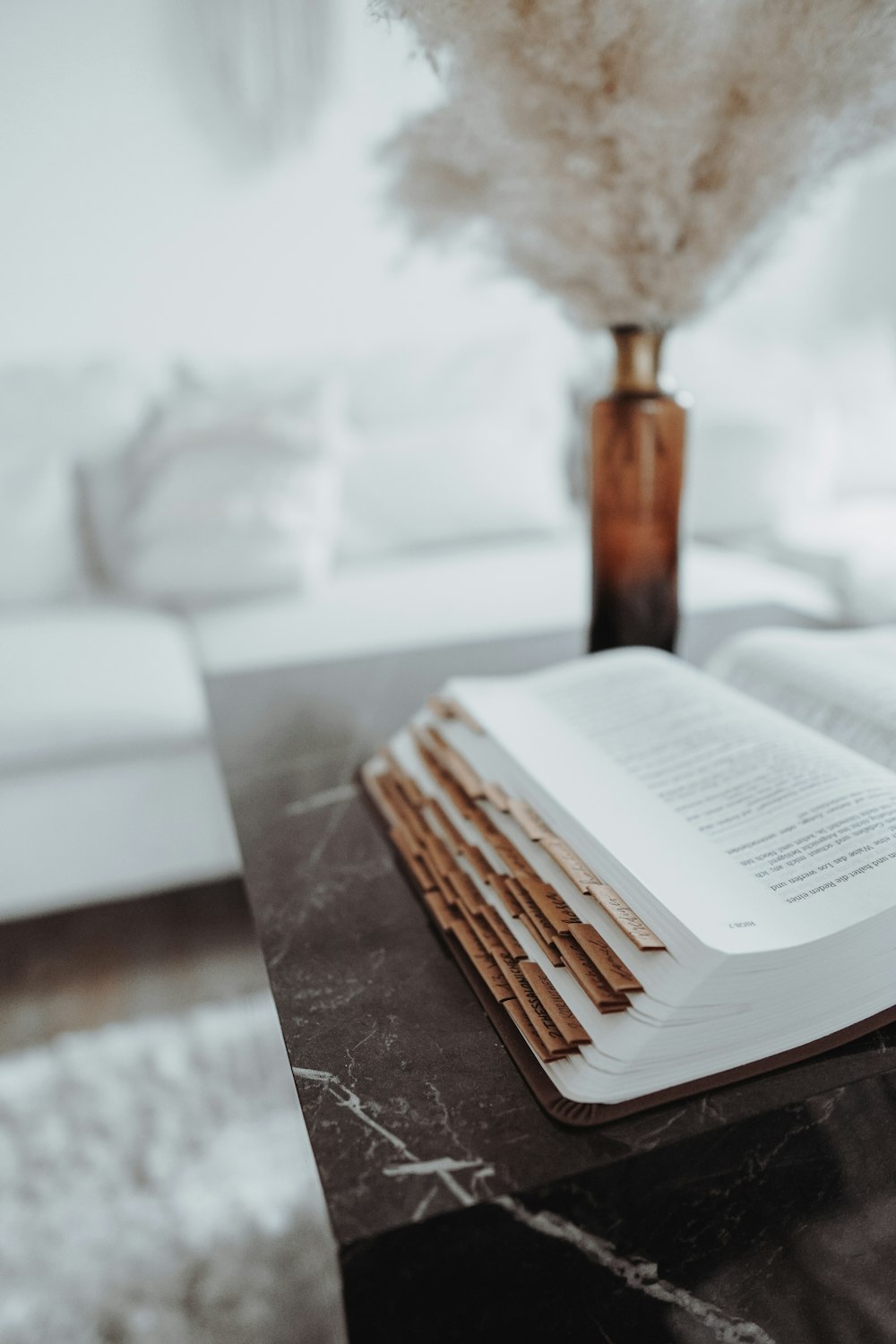 opened book on brown wooden table