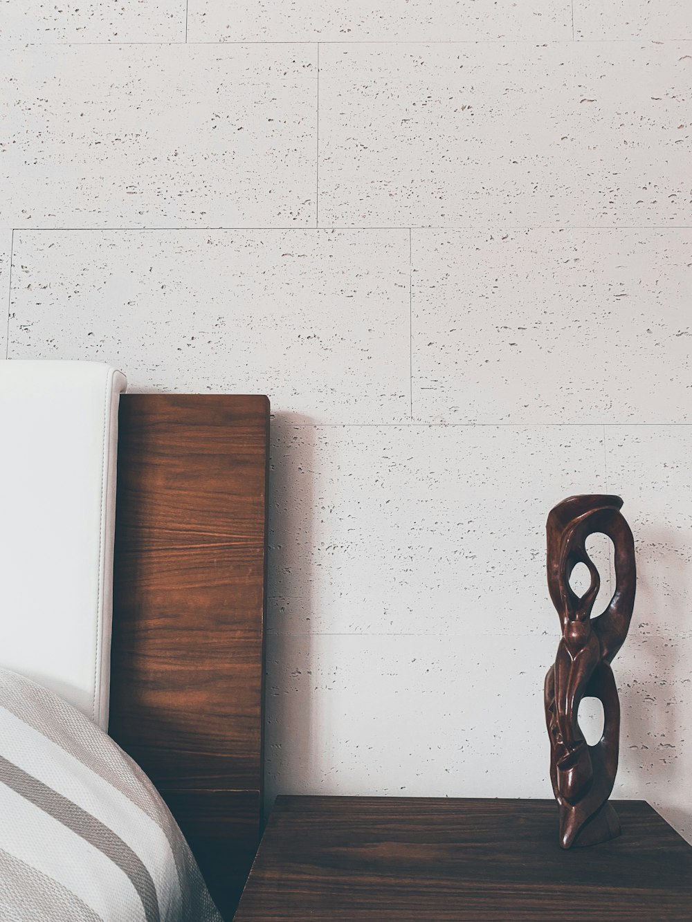 brown wooden chair beside white wall