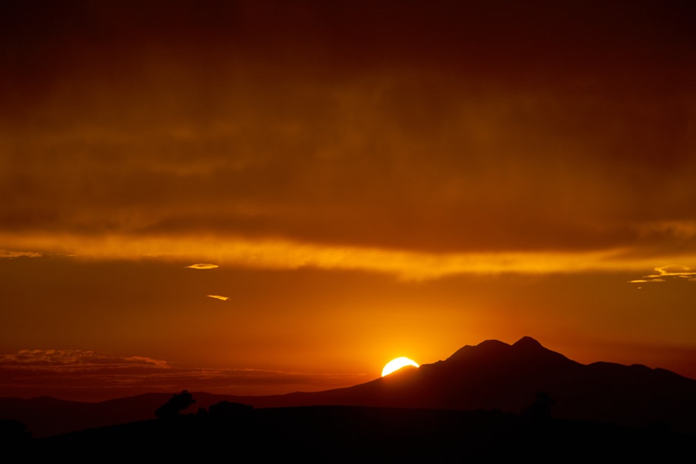 silhouette of mountain during sunset