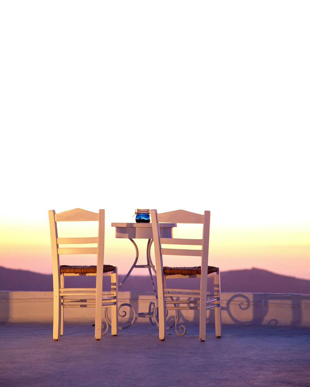 brown wooden table and chairs on brown sand during daytime