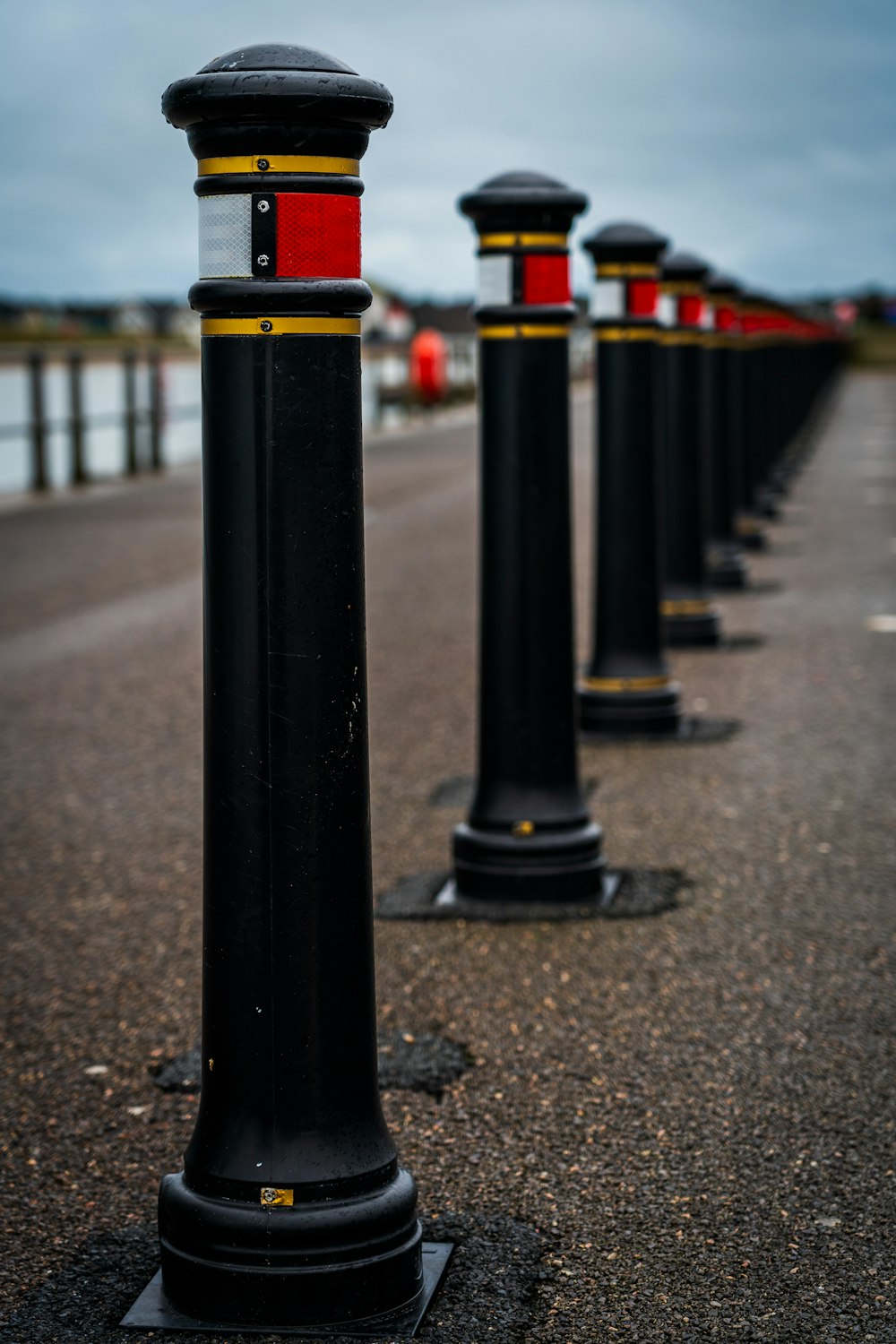 black and yellow metal post on gray concrete road during daytime