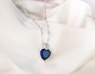 silver necklace with blue gemstone pendant