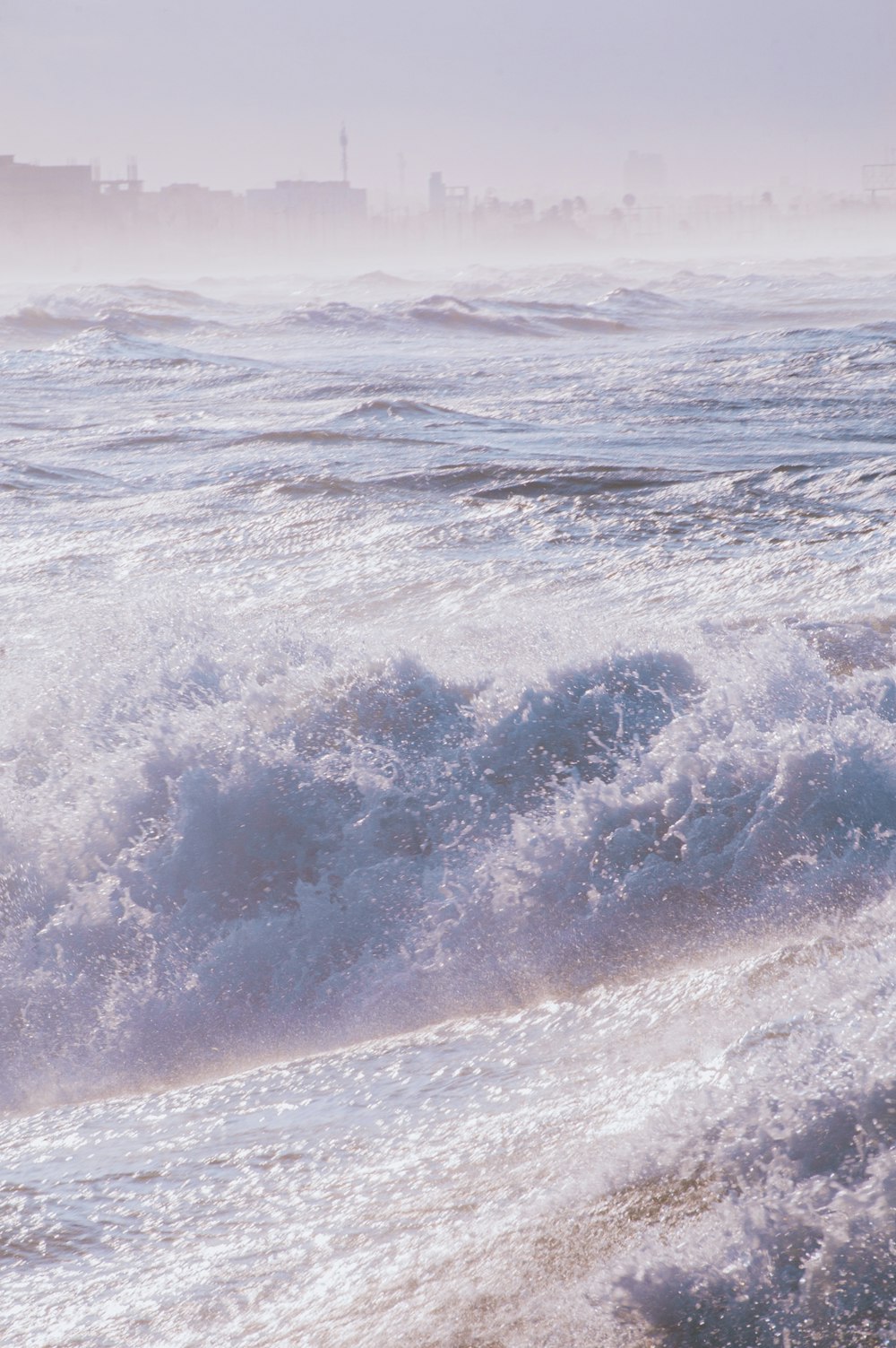 ocean waves crashing on shore during daytime