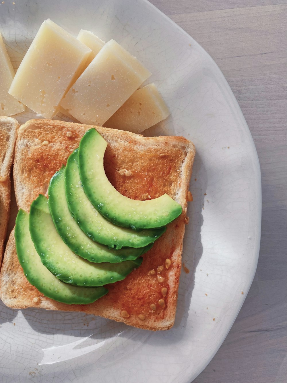 sliced bread with sliced cucumber on white ceramic plate