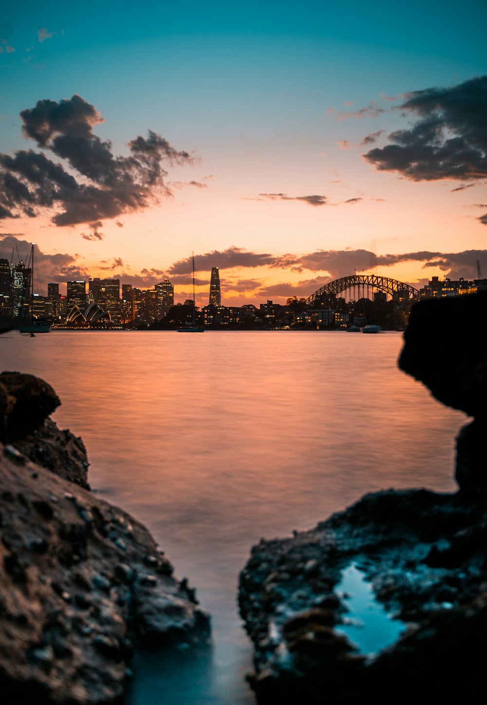 body of water near city buildings during night time