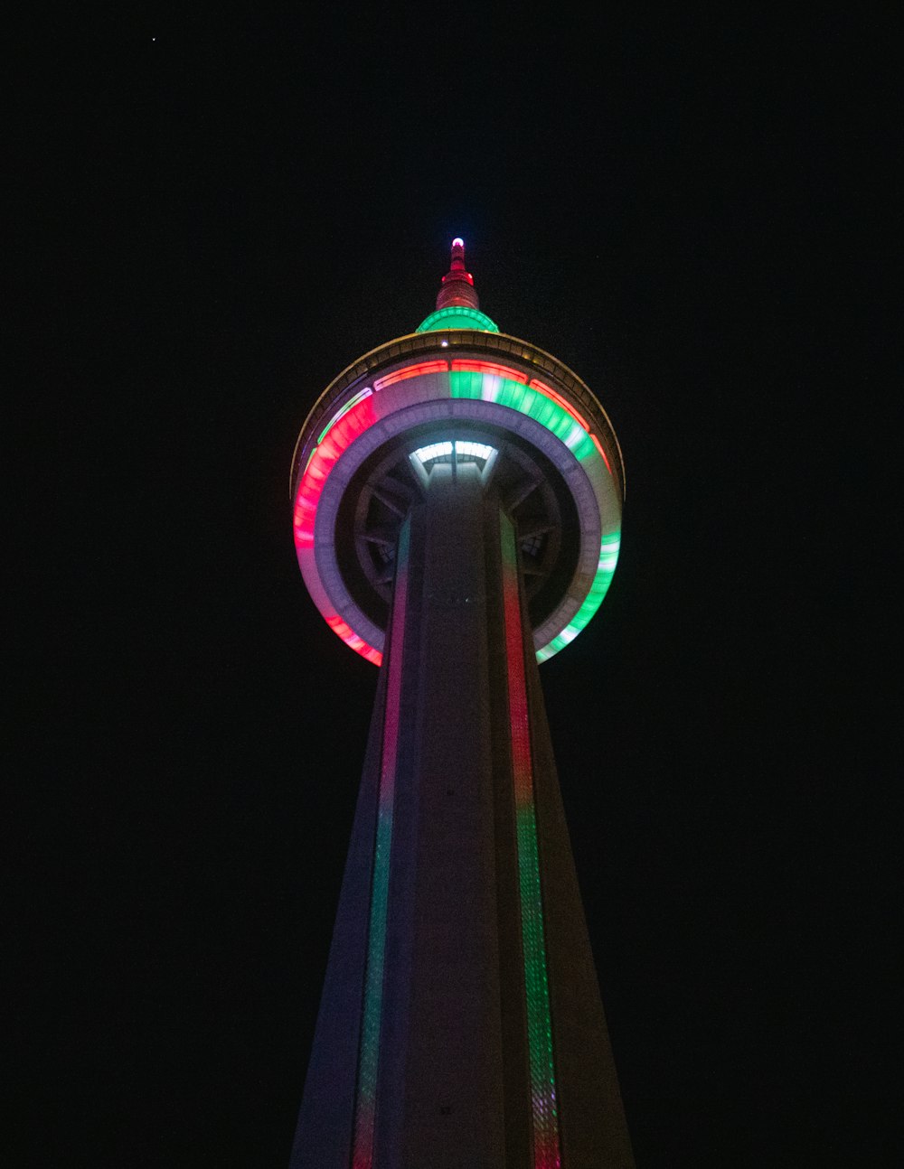 purple and green tower during night time