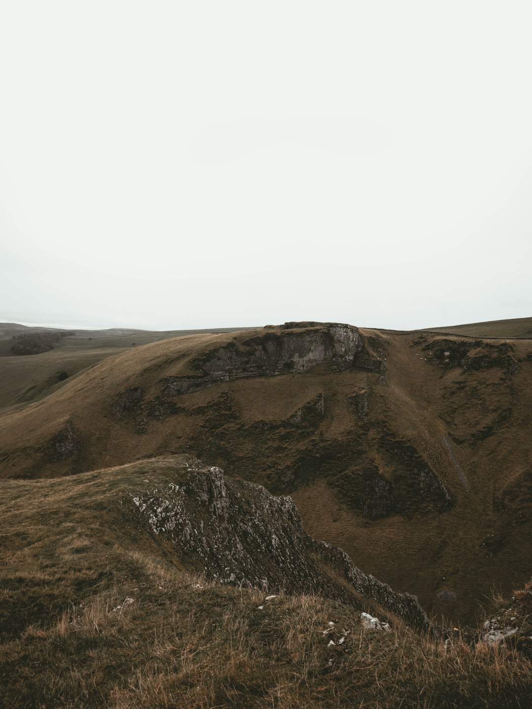 brown and green mountain under white sky during daytime