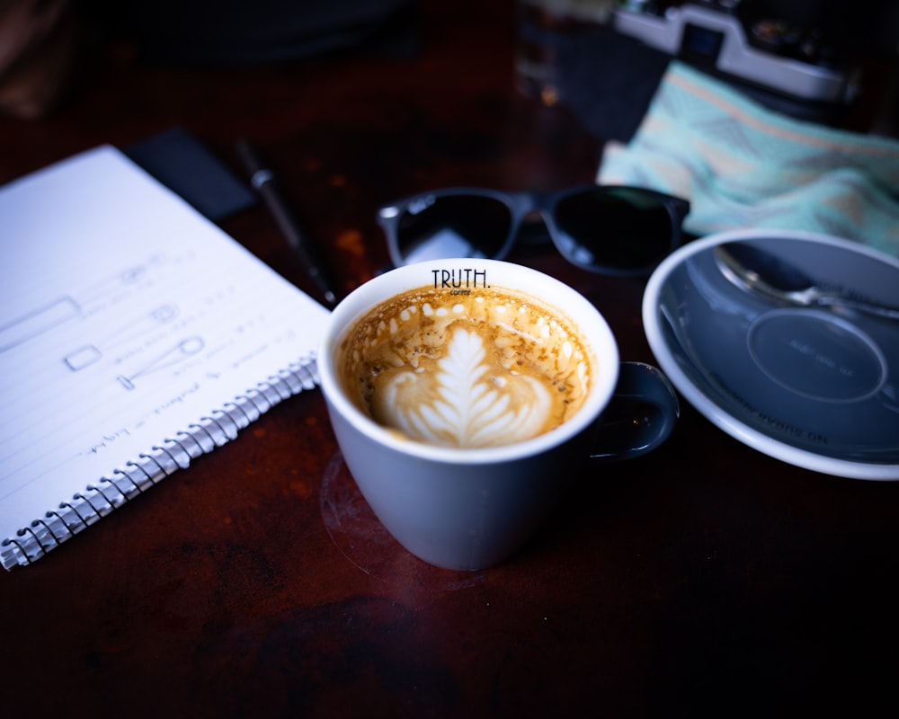 white ceramic cup with cappuccino