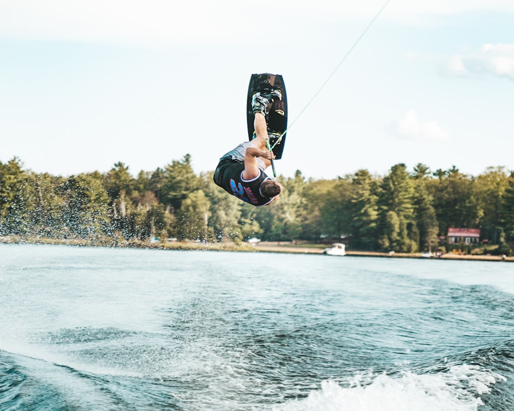 man in black jacket and black pants doing surfing during daytime