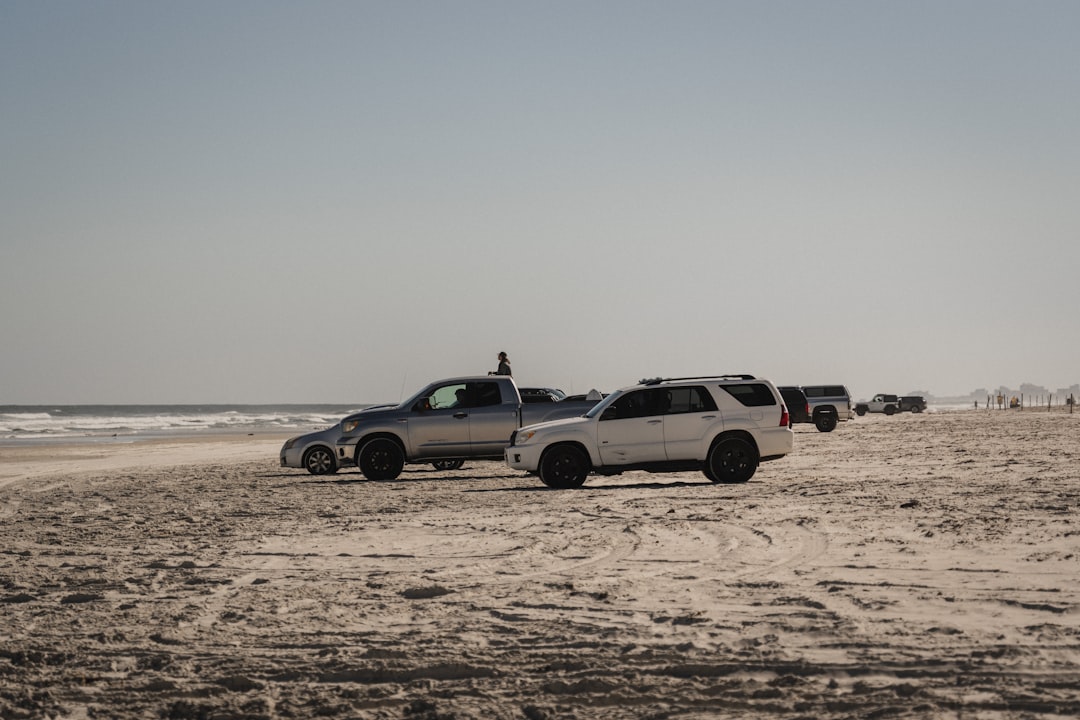 white and black suv on brown sand during daytime