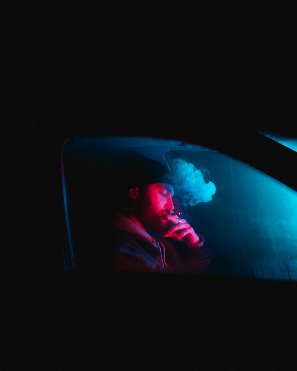 man in black jacket sitting inside car