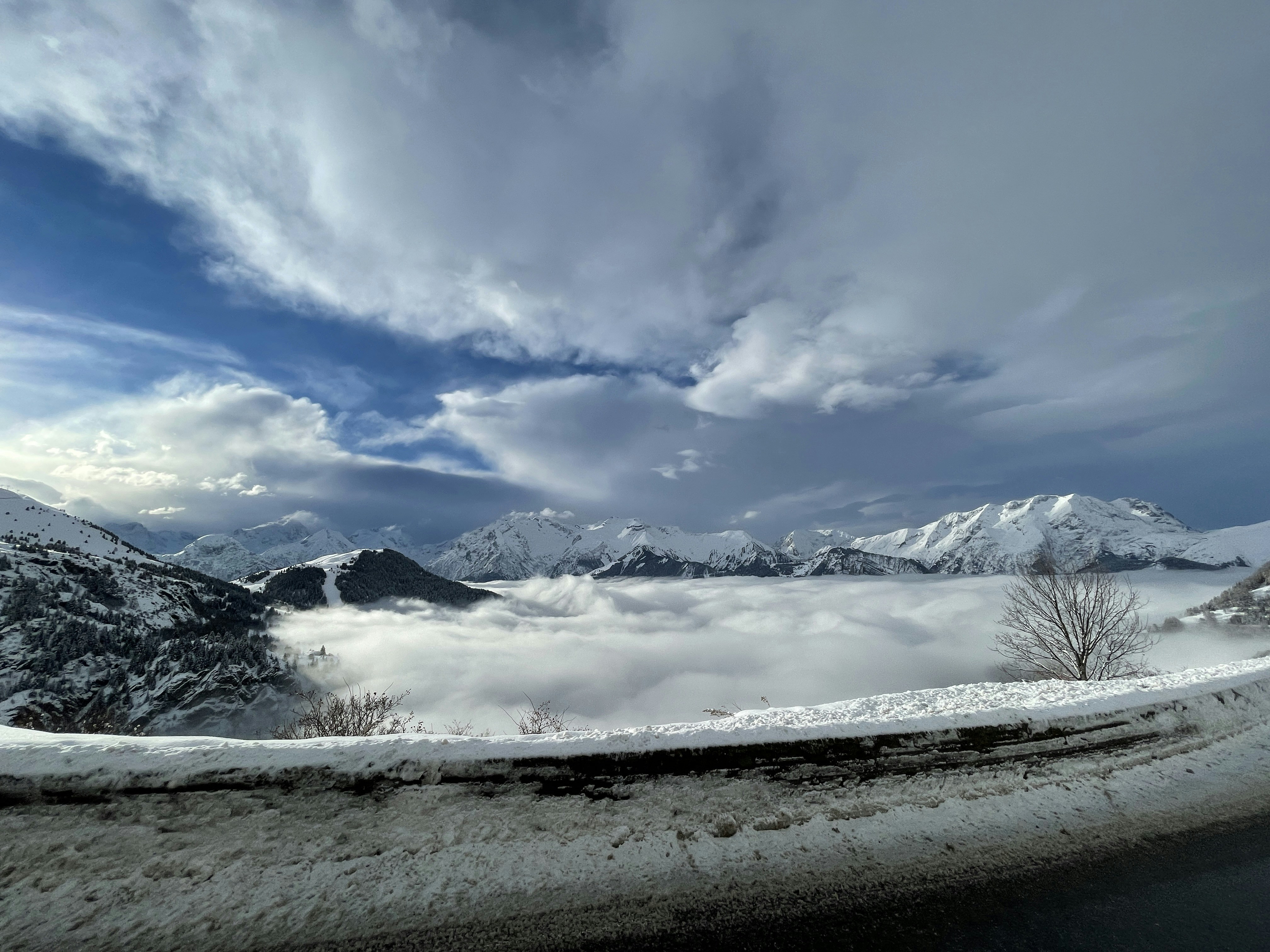 snow covered mountain under cloudy sky during daytime