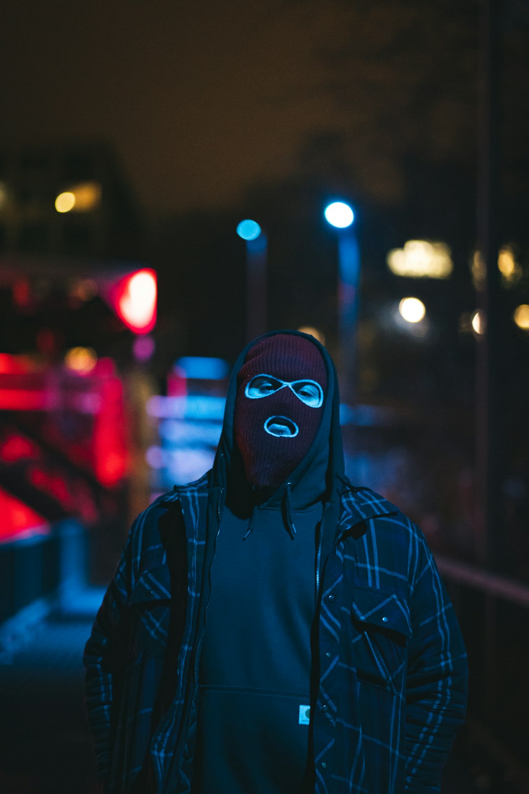 person wearing black and white jacket and mask