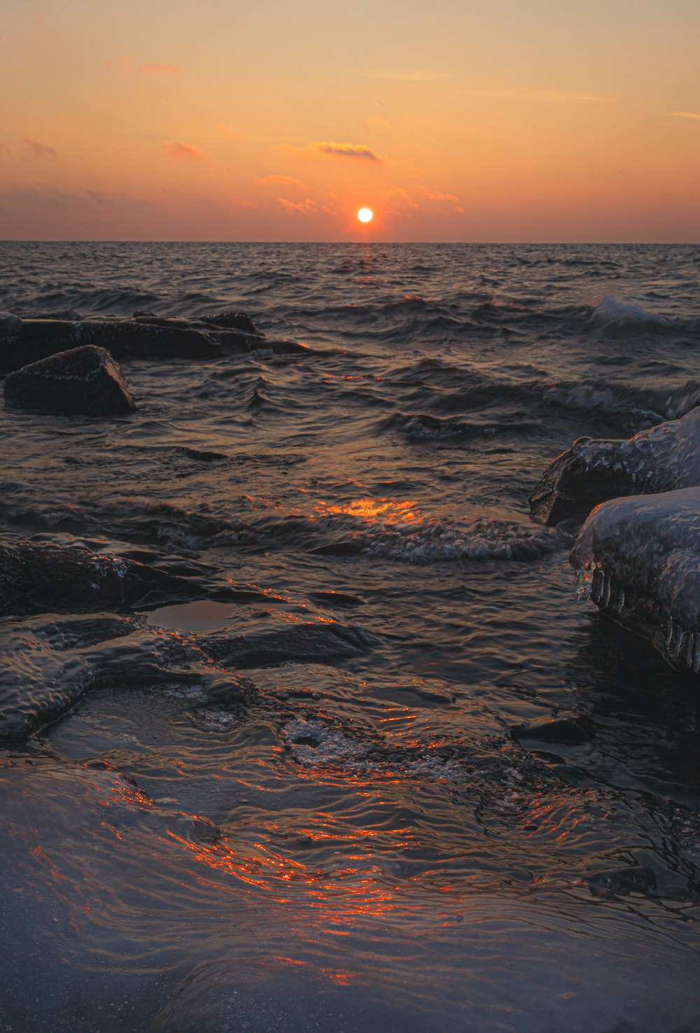 body of water during sunset