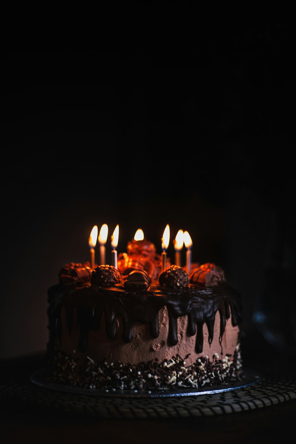 lighted candles on black metal stand