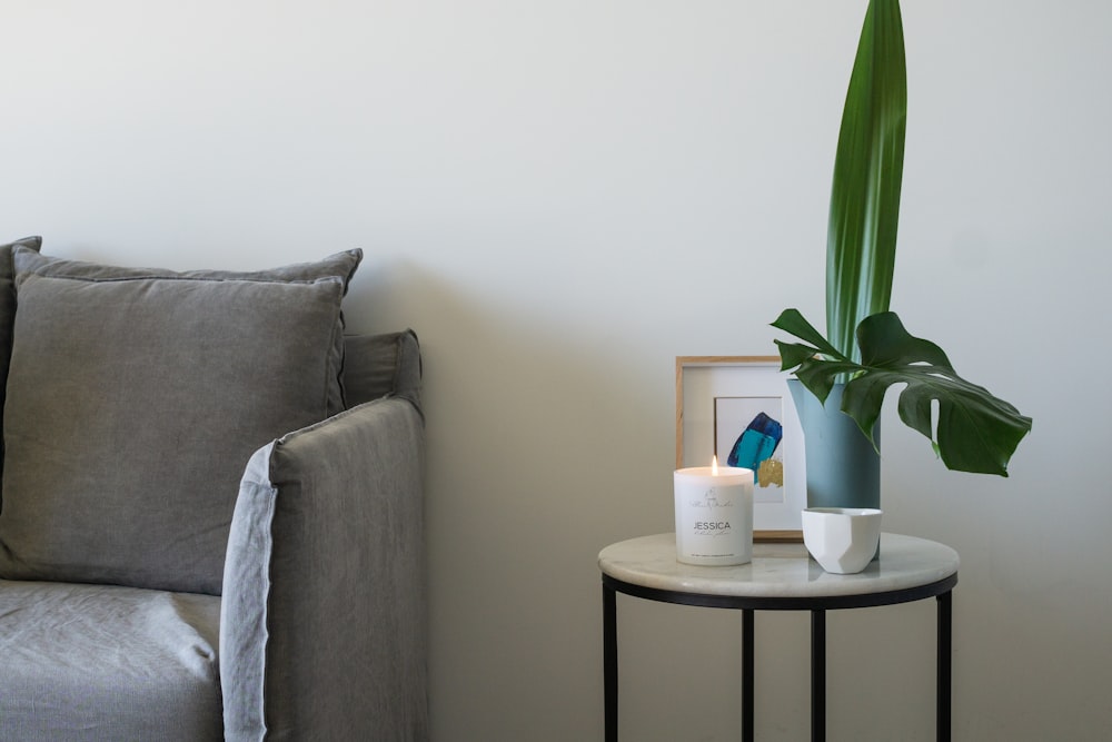 green plant on white ceramic pot on white round table