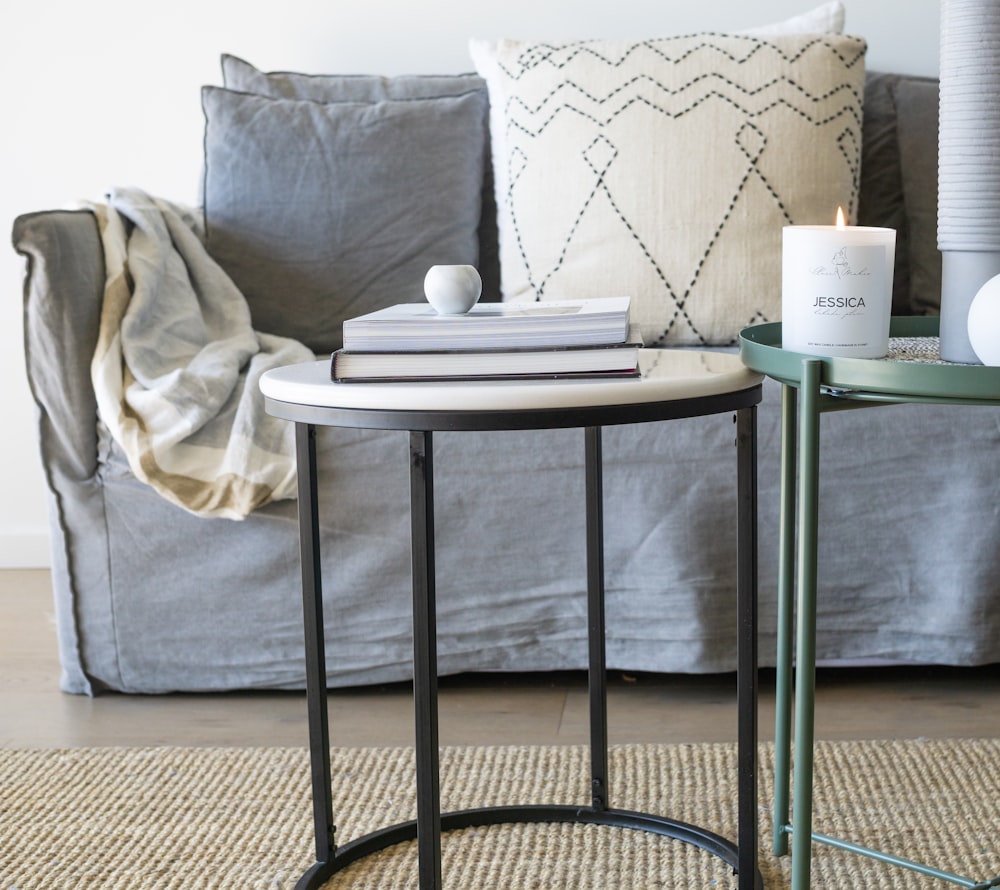 white and green ceramic mug on white round table