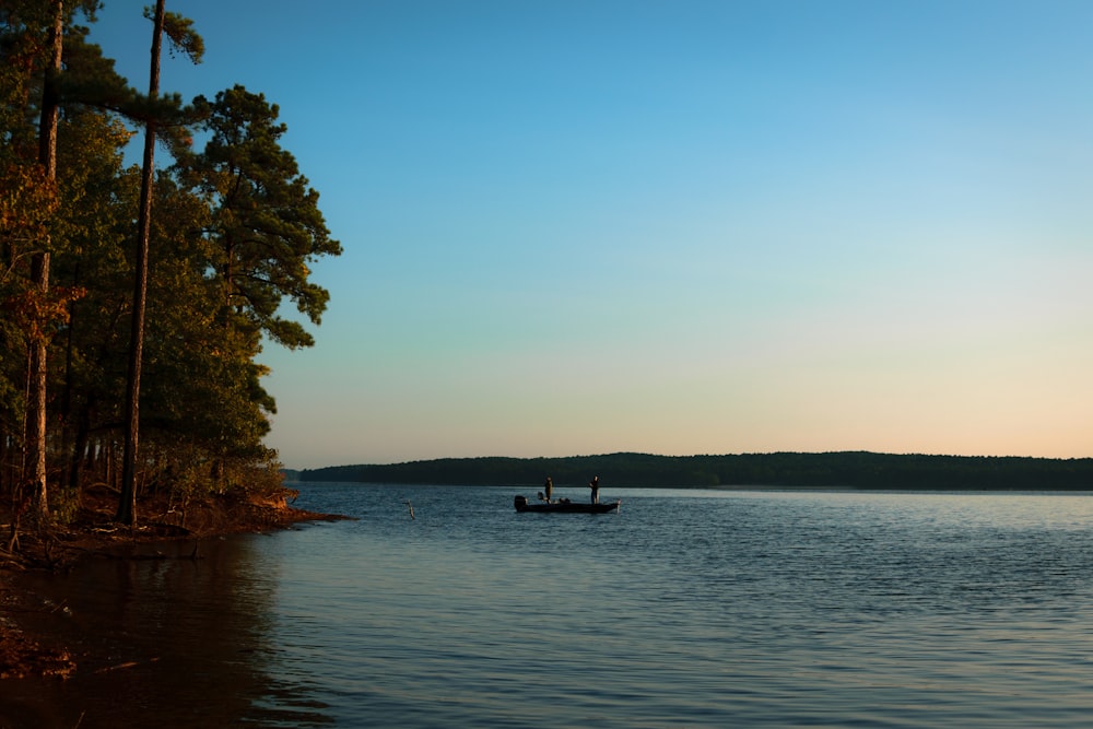 person sitting on boat on sea during daytime