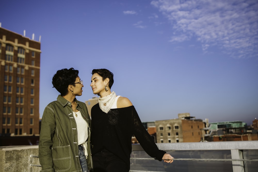 women standing near railings during daytime