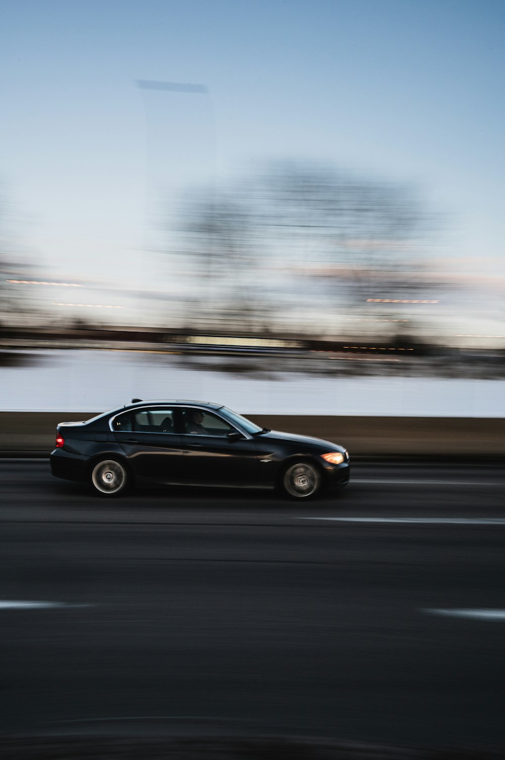 black sedan on road during daytime