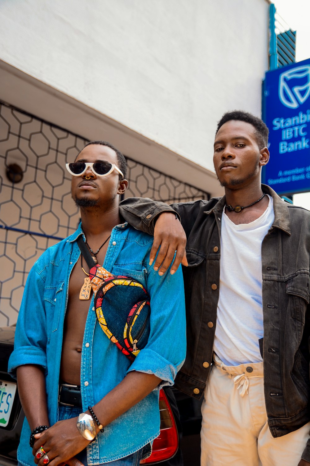 man in blue button up shirt beside man in blue denim jacket