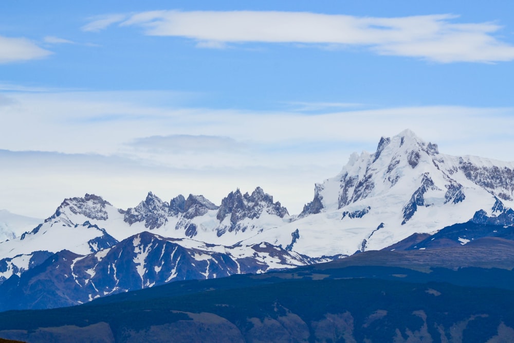 snow covered mountains under blue sky during daytime