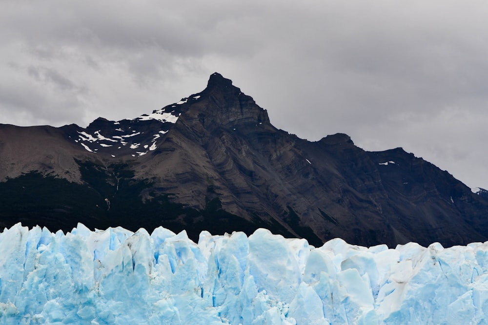 brown and white mountain under gray sky