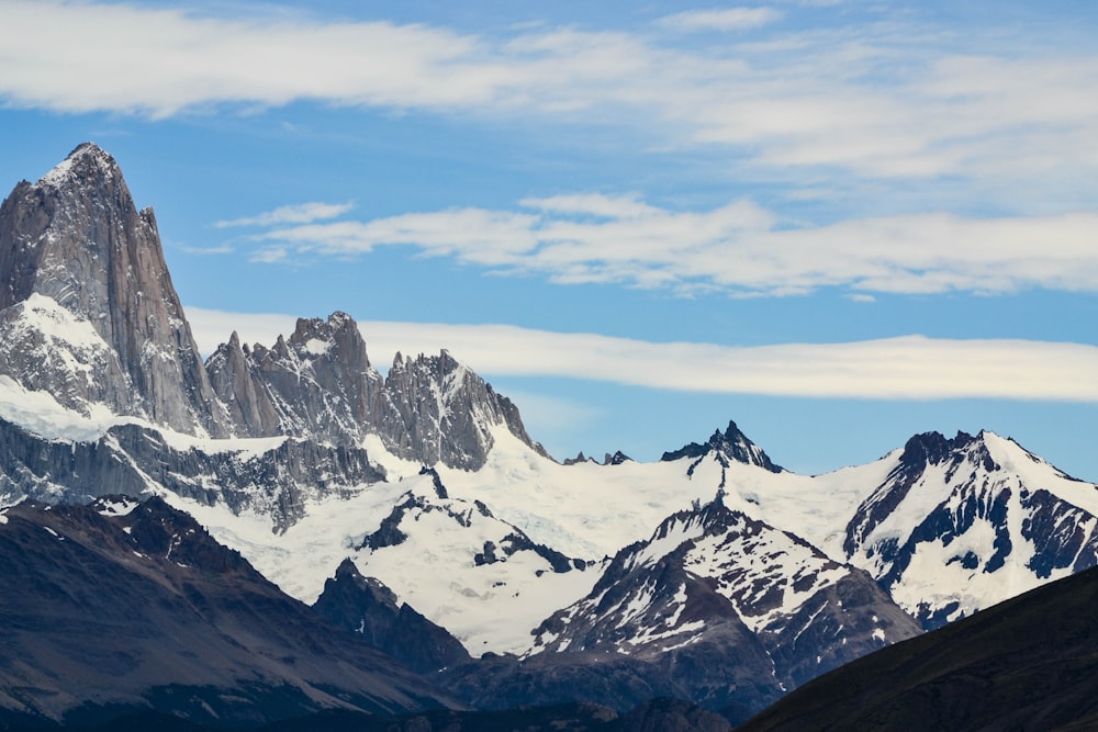 snow covered mountains under blue sky during daytime