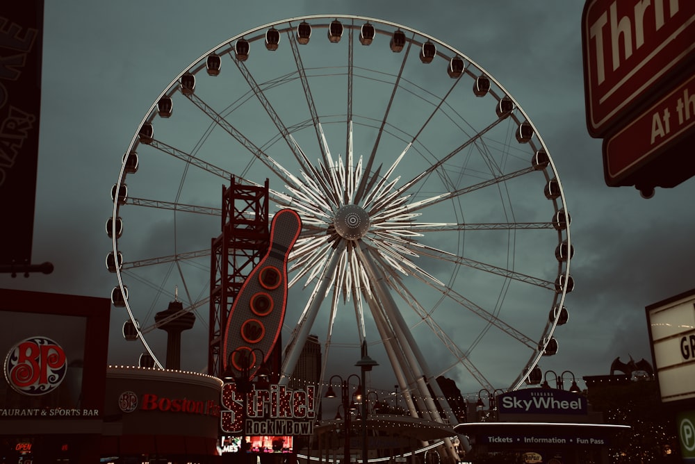 red and white ferris wheel under blue sky during daytime