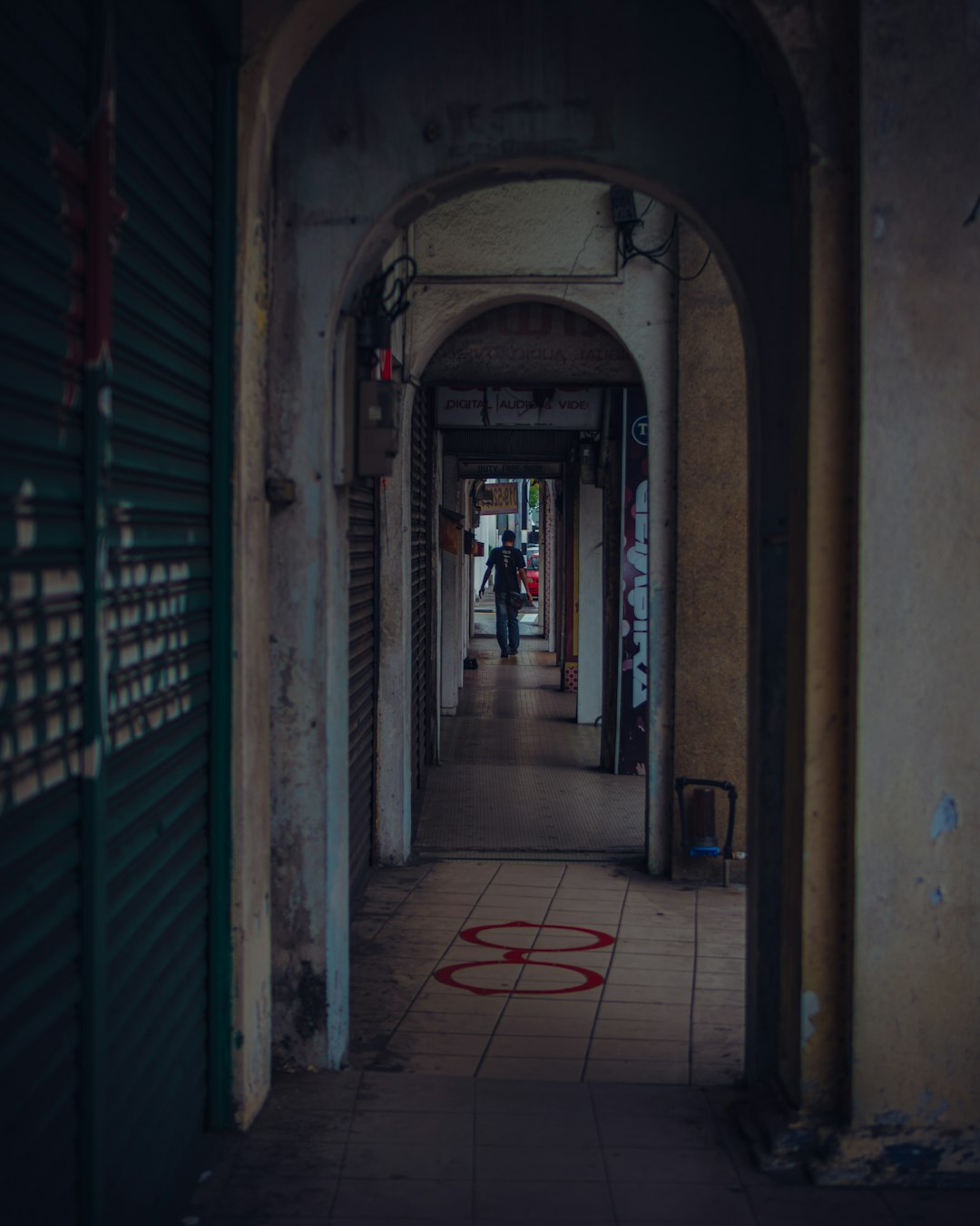 woman in black jacket walking on hallway