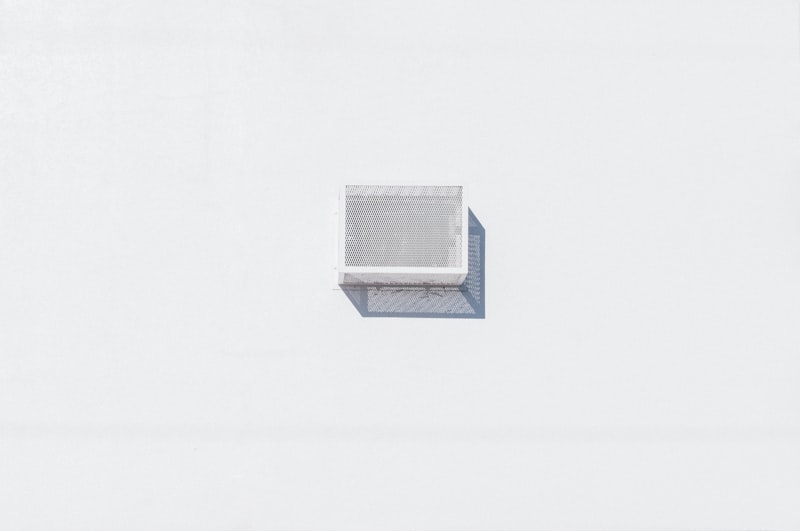 Minimal white air vent on a clean wall