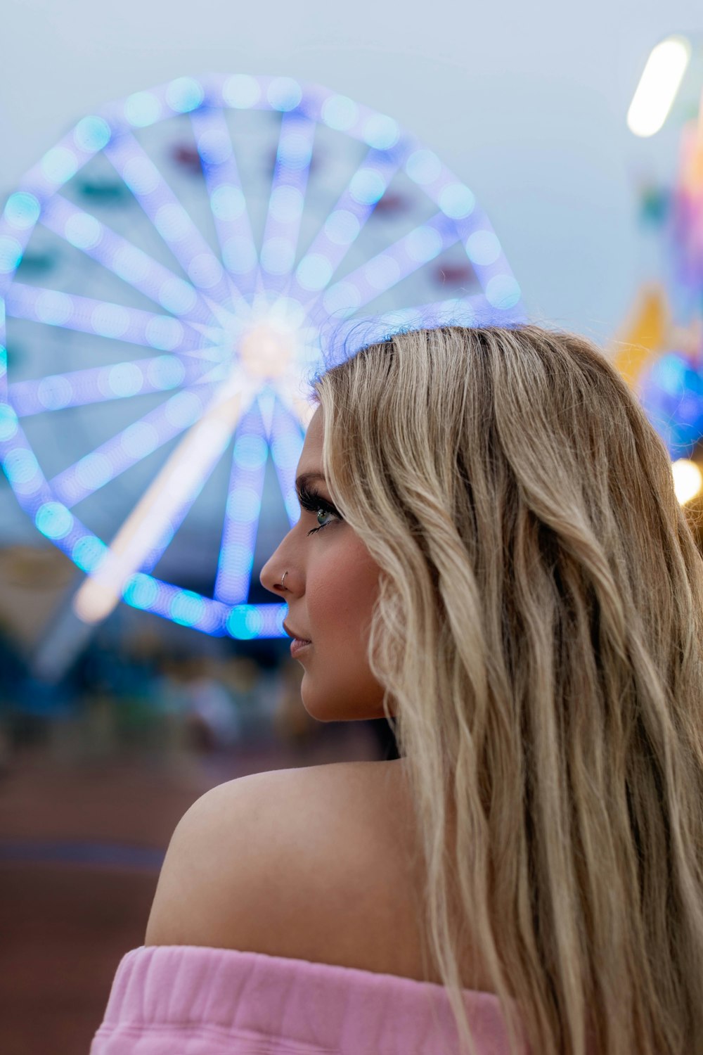 woman with blonde hair looking at the sky