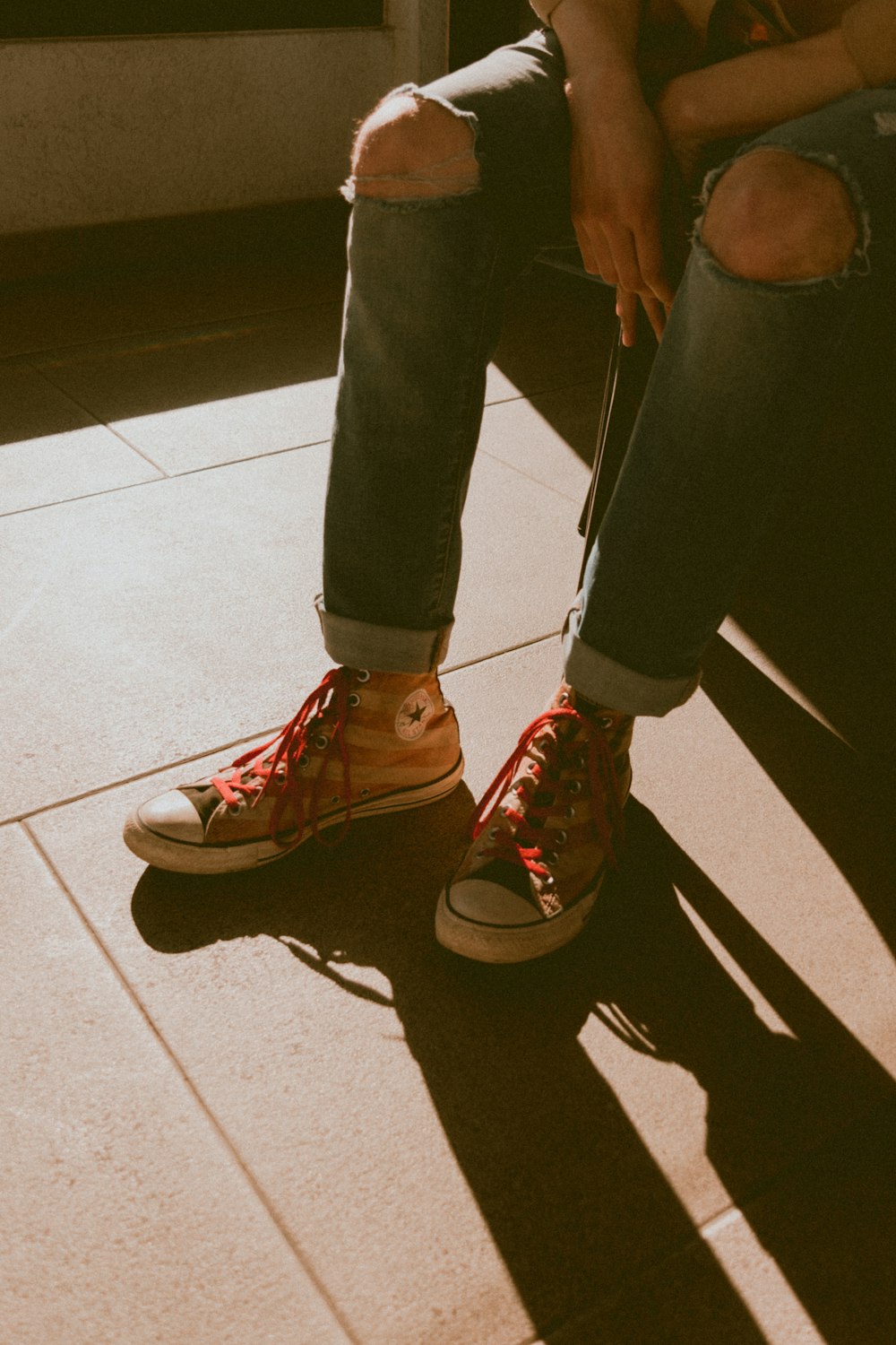 person in black pants and red nike sneakers