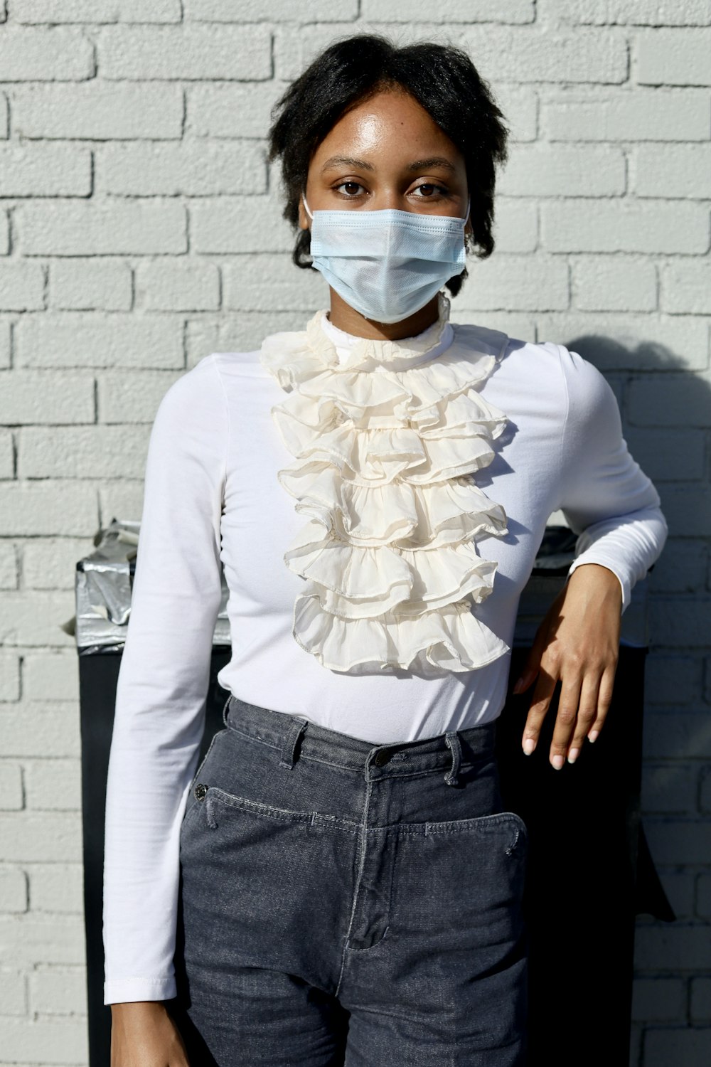 woman in white long sleeve shirt and blue denim jeans