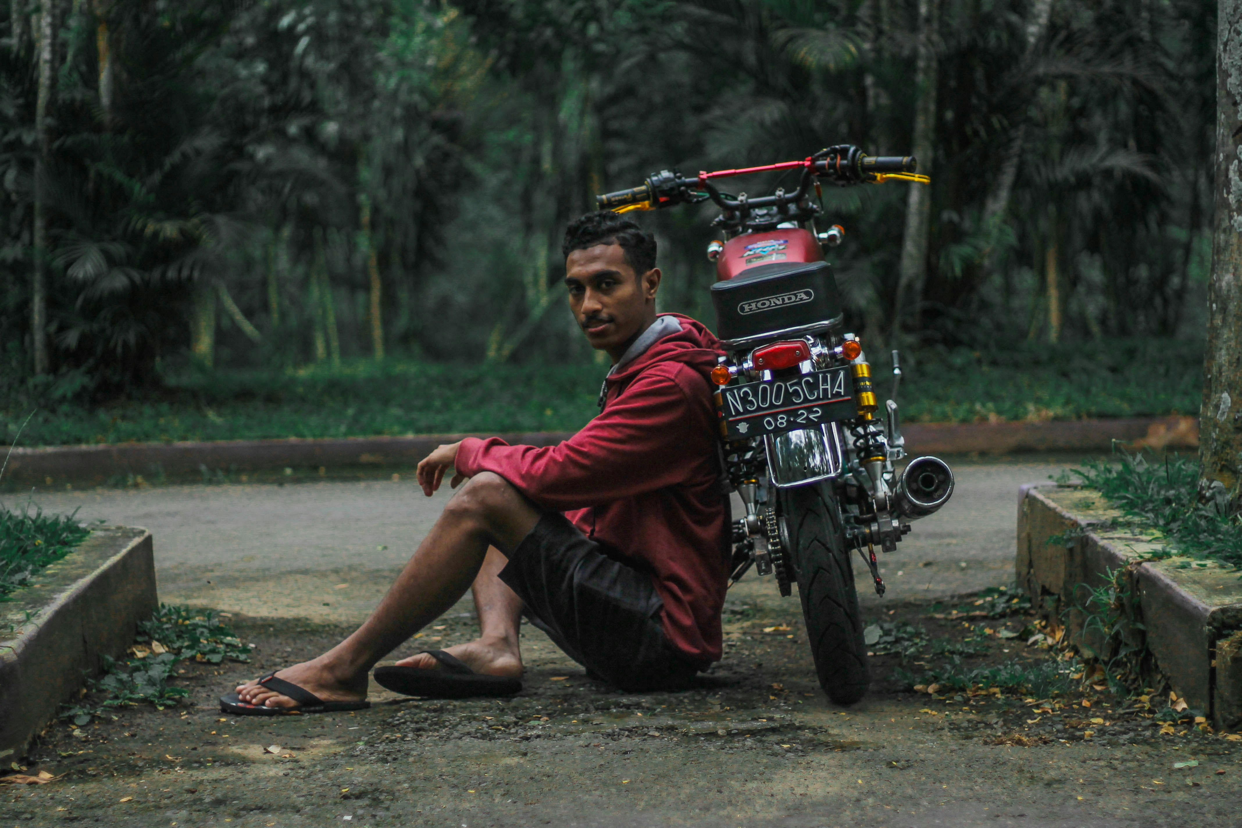 man in red and black long sleeve shirt sitting on motorcycle