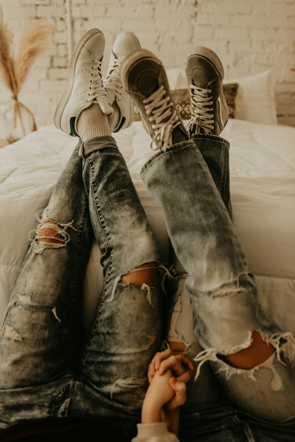 person in blue denim jeans and brown and white sneakers