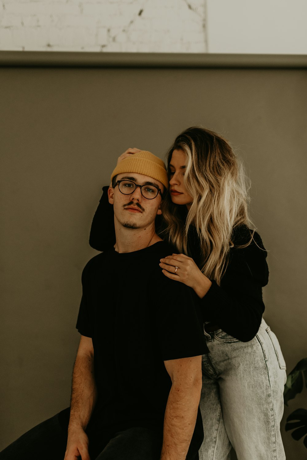 woman in black shirt and gray denim jeans standing beside woman in black shirt