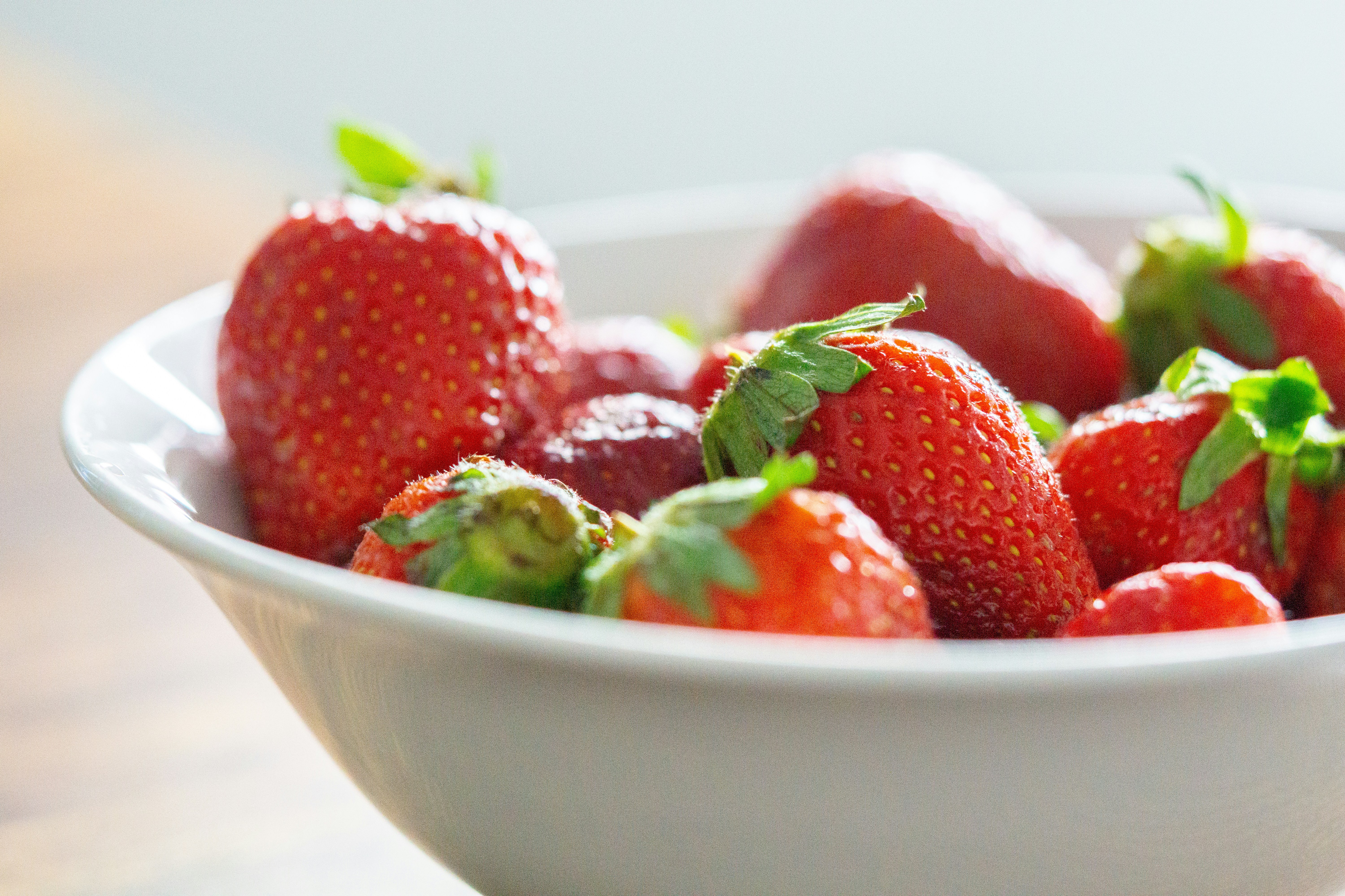 strawberries in white ceramic bowl
