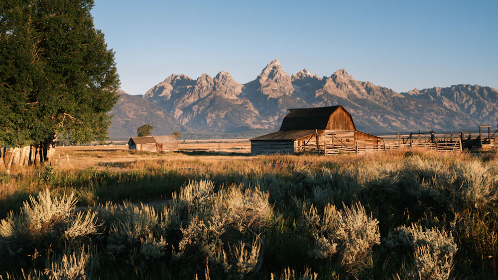 Dramatic barn scene near mountain landscape