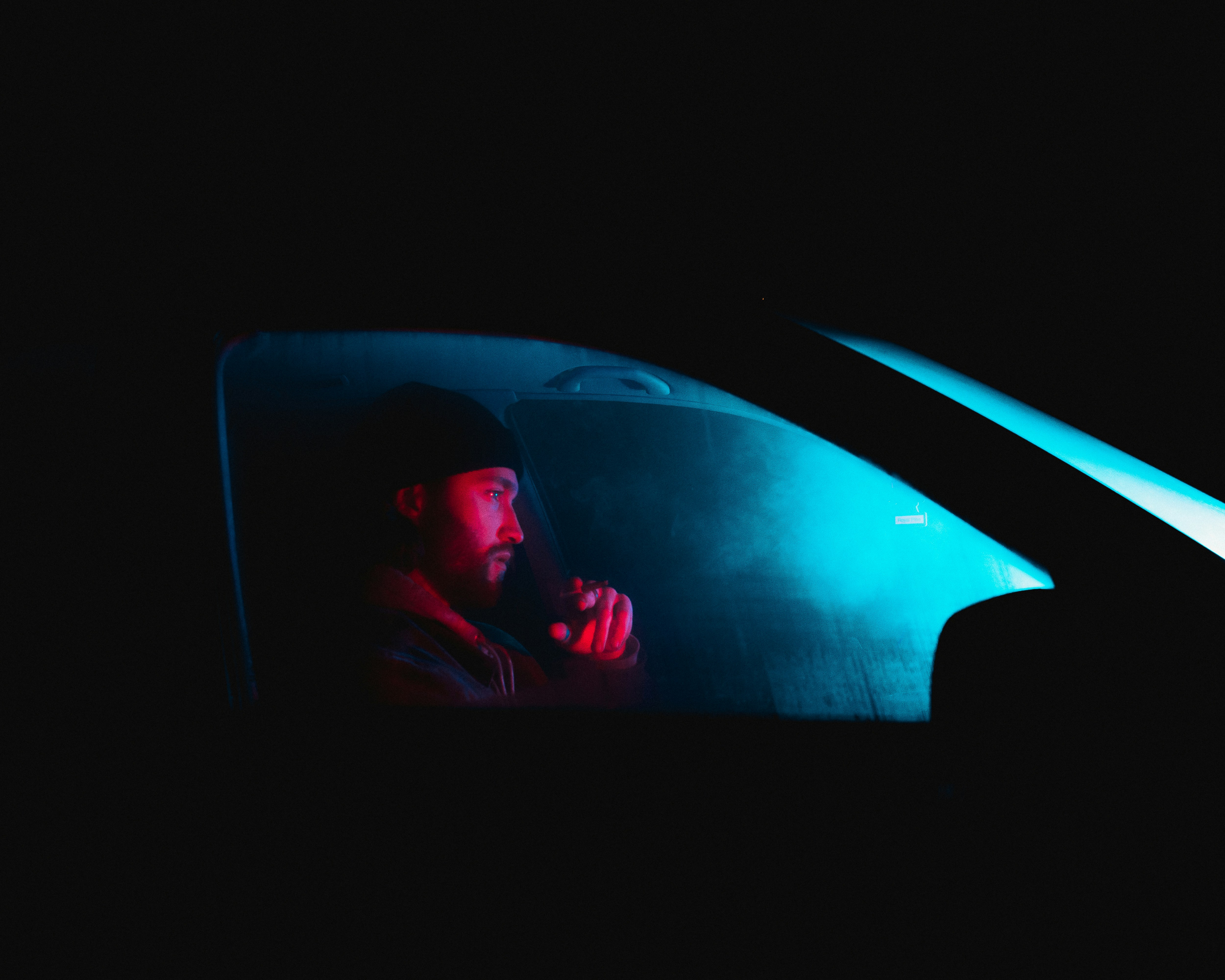 Neon portrait of man in car