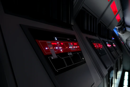 Futuristic industrial control room with blue and orange lighting reflecting advanced technology and teamwork.