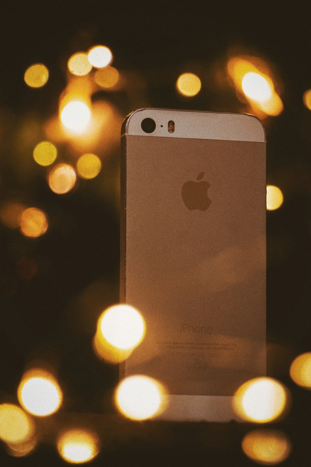 gold iphone 6 on bokeh photography