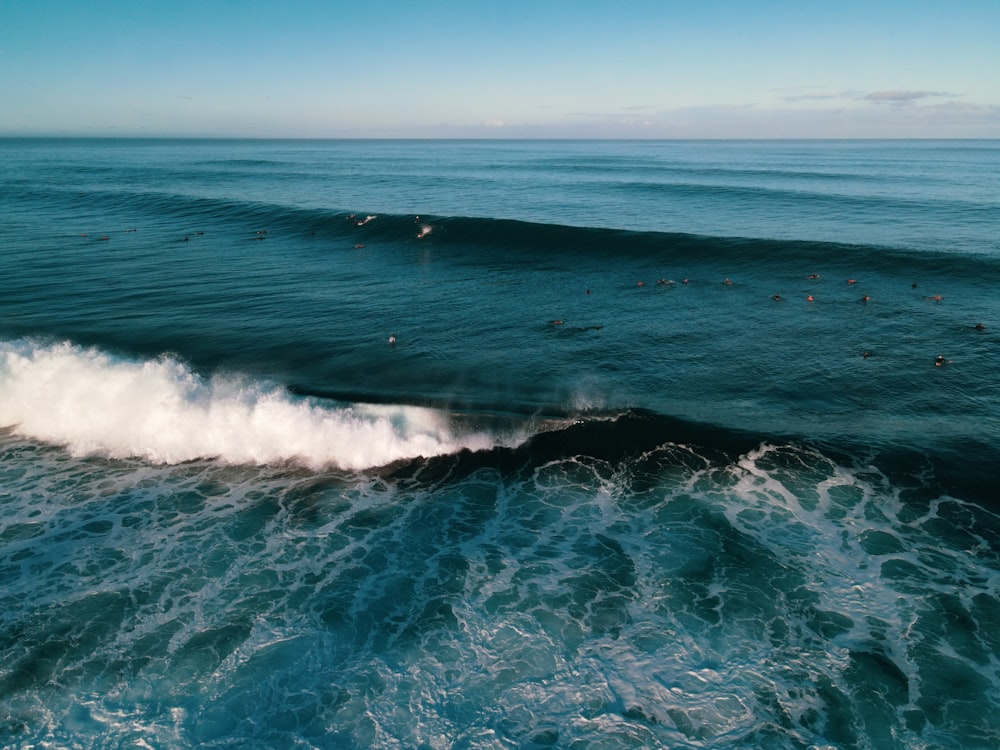 ocean waves crashing on shore during daytime