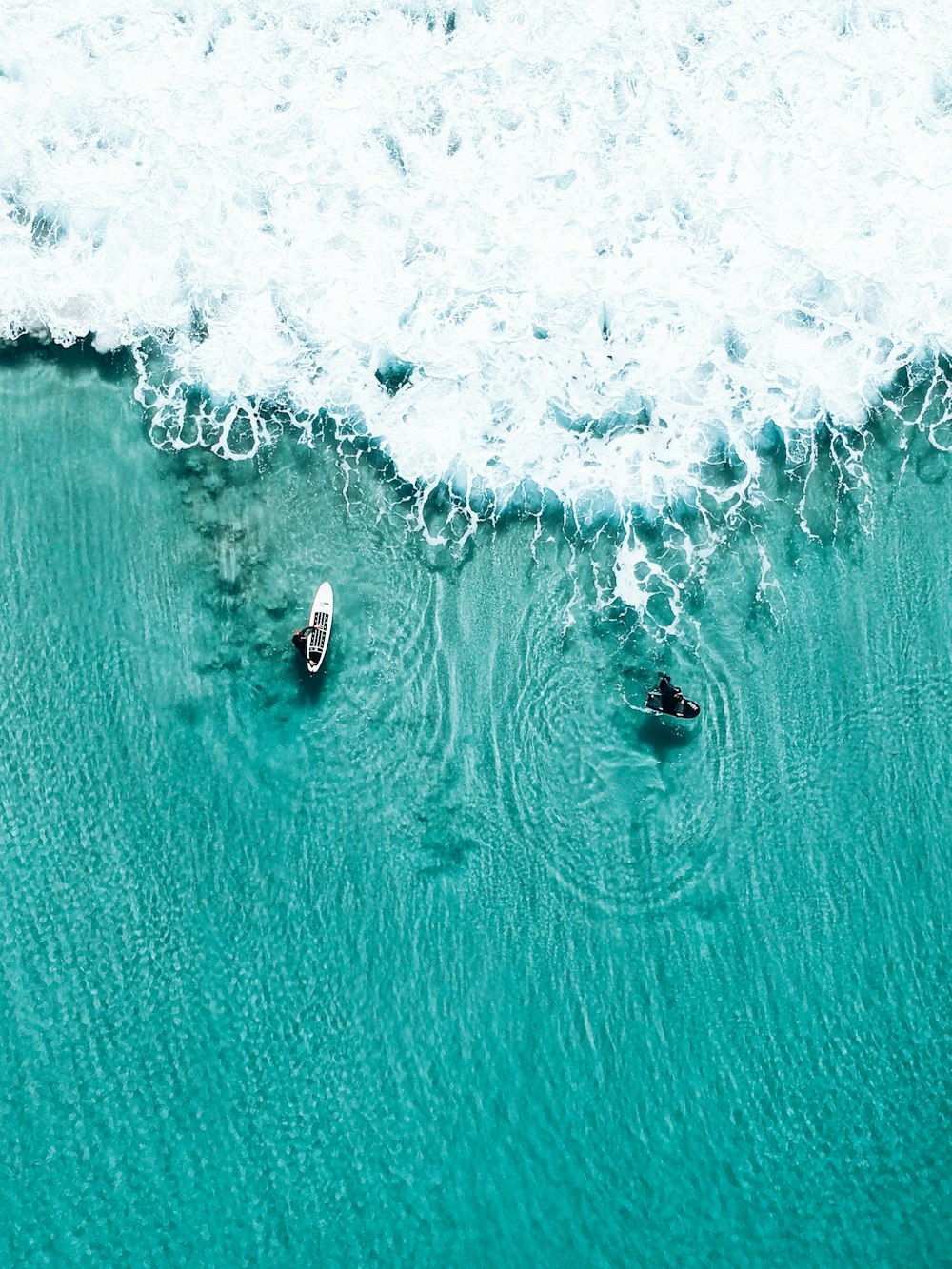 aerial view of person surfing on sea waves during daytime