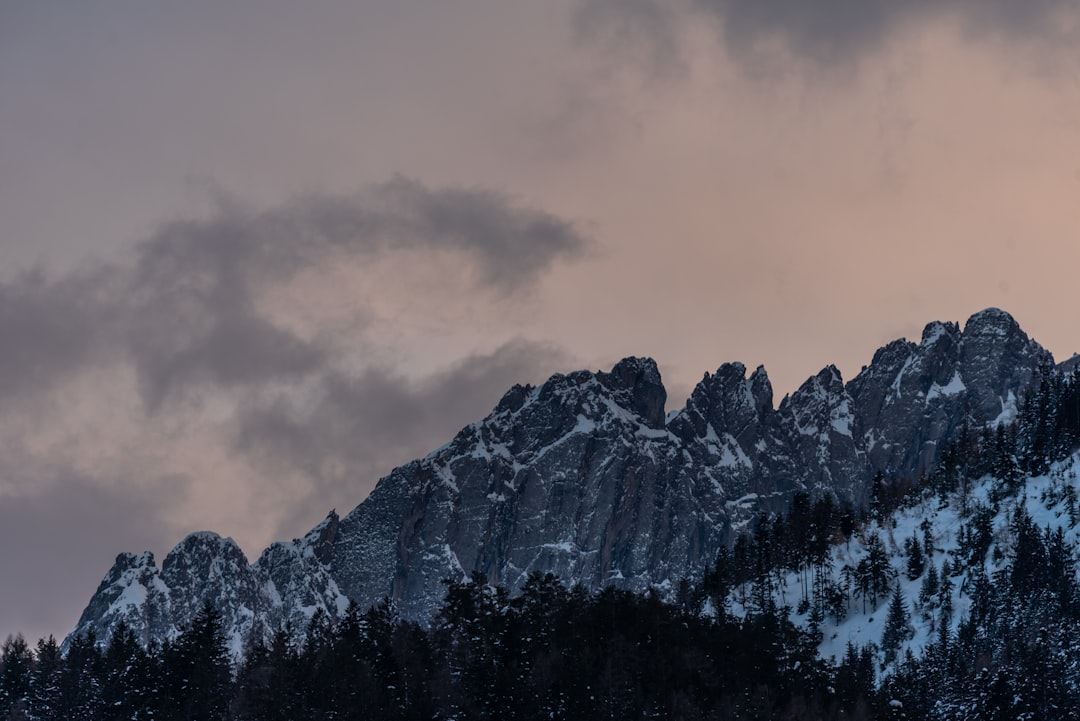 snow covered mountain under cloudy sky during daytime