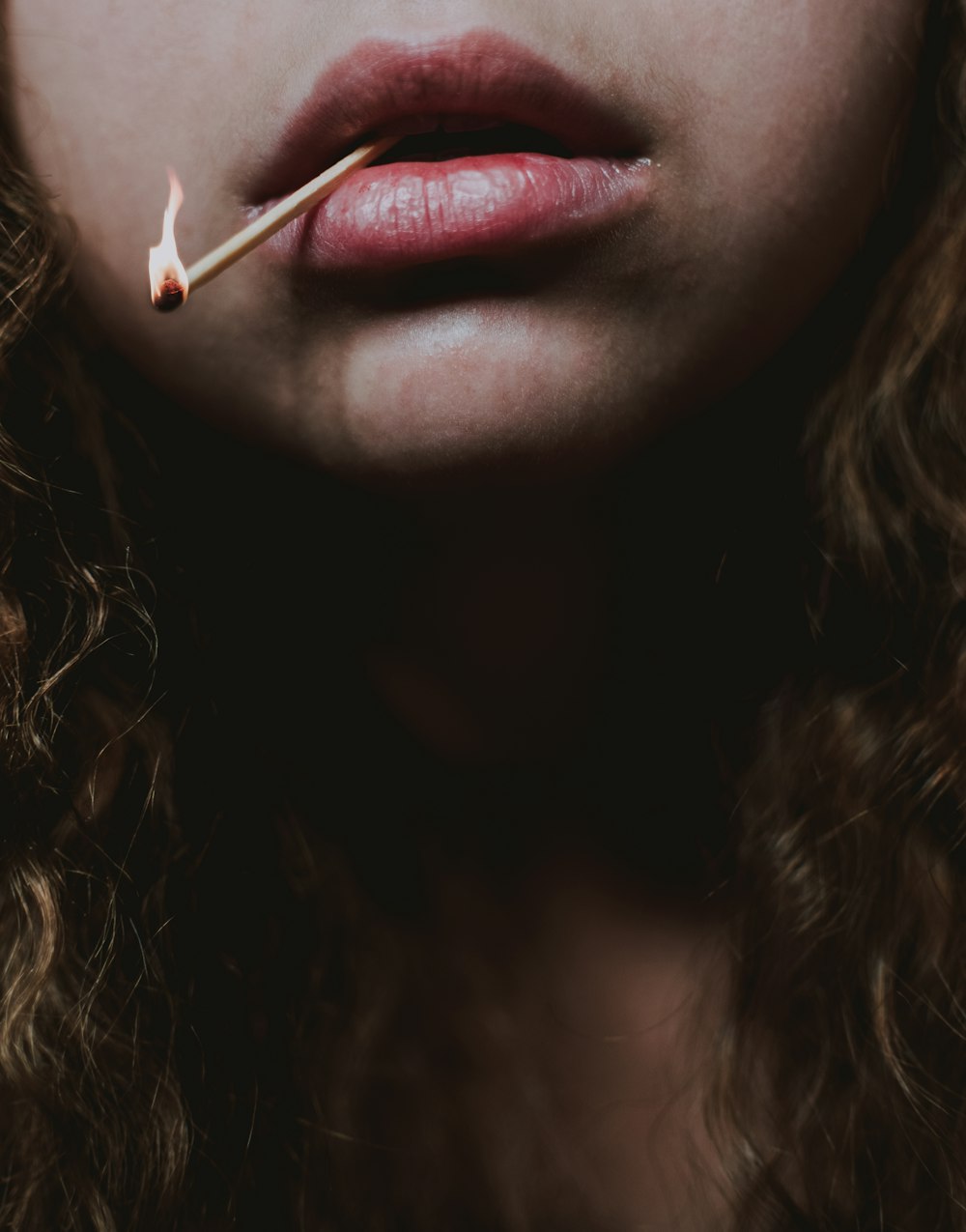 woman with red lipstick and white cigarette stick