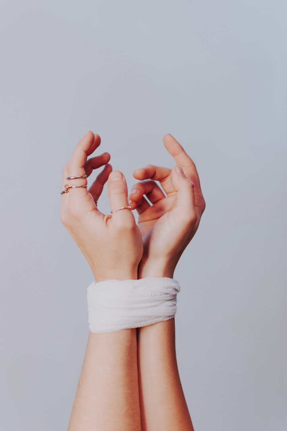 person wearing white gloves and silver ring