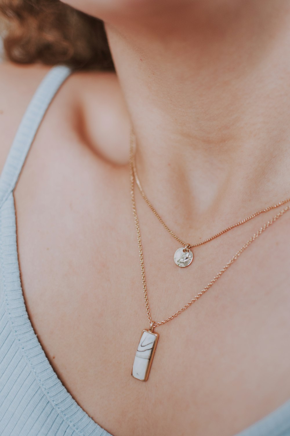 Woman wearing gold necklace with silver pendant photo – Free Necklace Image  on Unsplash