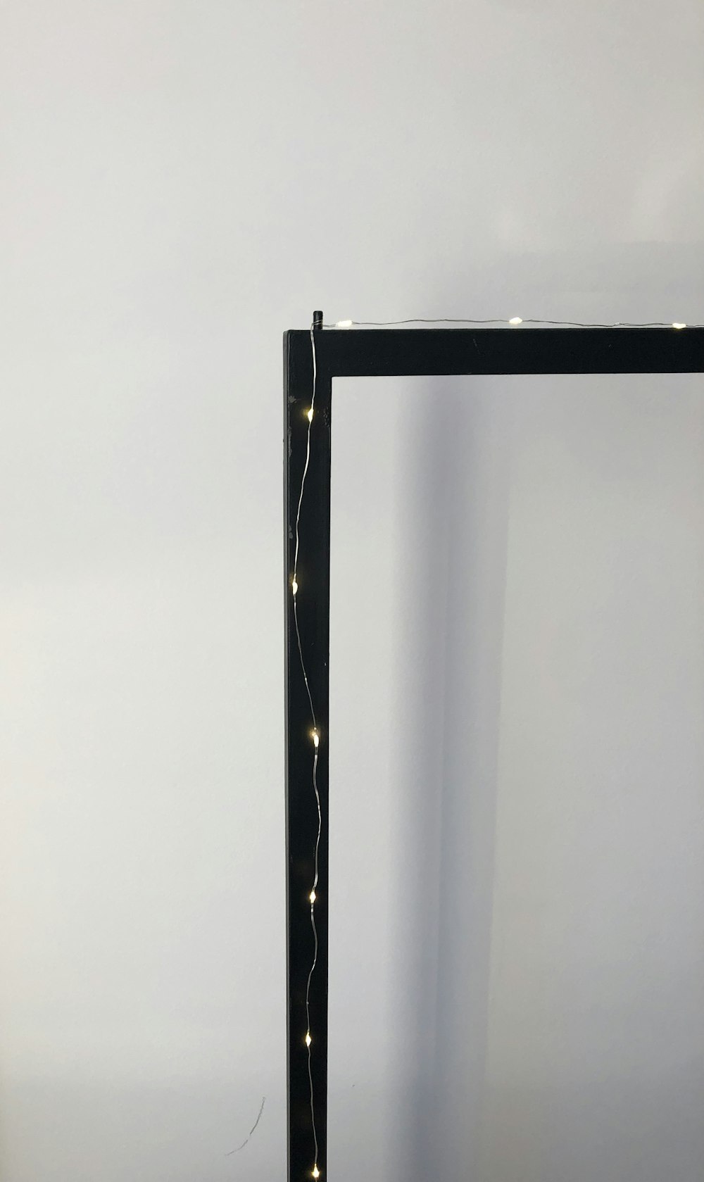 black metal frame near white wall